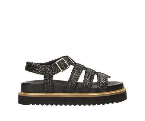 Step up your summer style with the 6GL0091002 2100 black gladiator-style slipper. Designed with sleek woven straps and a trendy flatform sole, this sandal is finished with an adjustable buckle closure for a secure and stylish fit. Perfect for casual days or evenings out, this bold design effortlessly elevates any outfit.