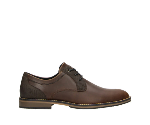 The Bullboxer 7ZZ1370302 3535 Dark Brown-Dark Brown PU Men's Shoe is a stylish and versatile option for those who appreciate a sleek, classic look. Featuring a rich dark brown color, this shoe effortlessly pairs with both business attire and casual outfits, providing comfort and sophistication in one.