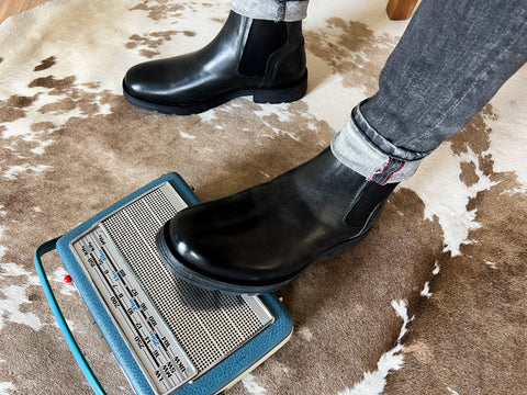 Step into effortless style with the 7JM0011301 2100 Black Chelsea Boot. This classic black boot for men features elastic tape on the sides for a snug fit and easy wear. Perfect for those who want to keep it sharp and comfortable, whether you're out on the town or heading to a casual outing.